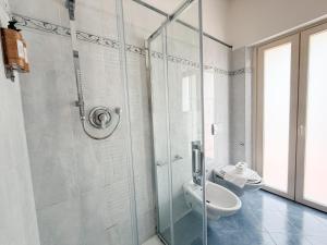 a bathroom with a toilet and a glass shower at Cuore di Nozzano Castello in Lucca +27 photos