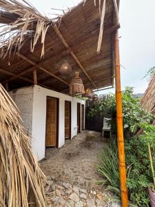 a patio of a house with a wooden roof at Mar y Montana in Taganga