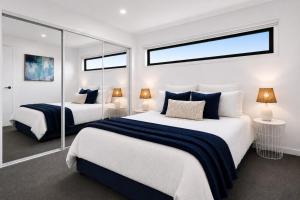 a bedroom with two beds and two windows at Albert Samian Retreat by Ready Set Stay - BYO sheets and towels in Capel Sound