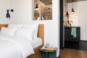 a bedroom with a bed and a table at STAYERY Berlin Friedrichshain - stylish Rooms & Apartments in Berlin +20 photos