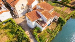 an overhead view of a house on the water at Interbeira Sandomil River Cottage in Seia