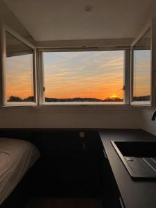 a bedroom with a window and a desk with a laptop at Le miroir secret in Anglet +14 photos