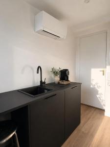 a kitchen with a sink and a counter top at Le miroir secret in Anglet