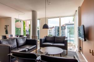 a living room with couches and a table at Kolding Hotel Apartments in Kolding