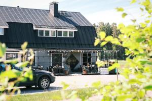a car parked in front of a building at Bed & Breakfast Restaurang Sybarit in Houtskari