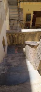 an old stairway with a bench and stairs in a building at Calvi centre ville in Calvi