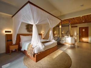 a bedroom with a large bed with a canopy at Samawa Living in Paje +94 photos