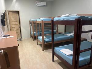 a room with three sets of bunk beds at B&S Pension House in Dipolog +2 photos