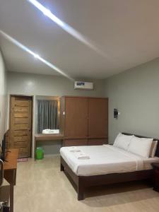 a bedroom with a large bed and a light on the ceiling at B&S Pension House in Dipolog