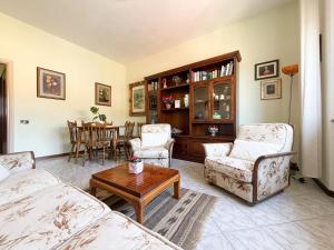 a living room with two chairs and a table at Cuore di Nozzano Castello in Lucca