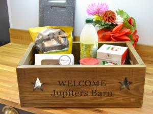 a wooden box with the words welcomeriors bank on it at Jupiter Barn in Swafield