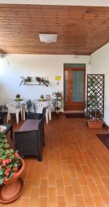 a living room with tables and chairs and a table at Vacanze a Colori in Porto Recanati