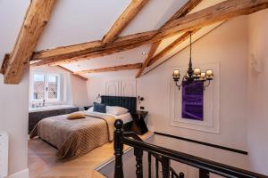 a bedroom with a bed in a room with wooden beams at Villa Ofellia in Dubrovnik