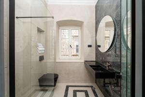 a bathroom with a black sink and a mirror at Villa Ofellia in Dubrovnik +33 photos