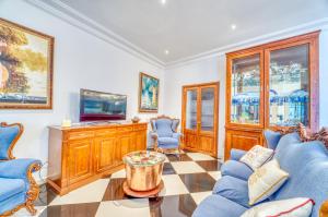 a living room with blue chairs and a tv at Ideal Property Mallorca - Can Peret in Sa Pobla