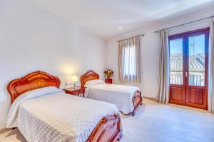 a hotel room with two beds and a window at Ideal Property Mallorca - Can Peret in Sa Pobla +30 photos