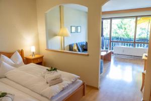 a bedroom with a bed and a large mirror at Hotel Sonnenhof in Bad Birnbach