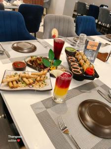 a table with plates of food and drinks on it at Riviera Hotel and Resort in Choli