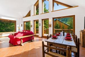 a living room with a table and a couch at Hostdomus - Chalet Claviere in Claviere