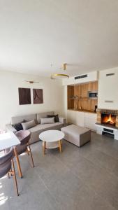 a living room with a couch and a fireplace at Waterside Houses in Ognyanovo