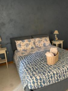 a bedroom with a bed with a basket of towels at A due passi dal mare 2023 in Nettuno