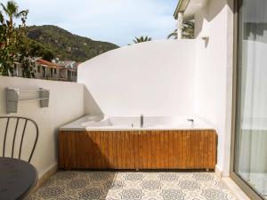 a bathroom with a bath tub on a balcony at Kassandra Oludeniz in Oludeniz