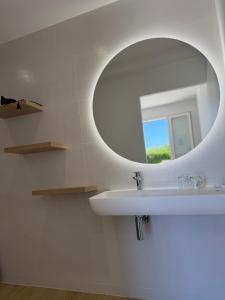 a bathroom with a white sink and a mirror at Hotel Thalassa in Cargèse +133 photos