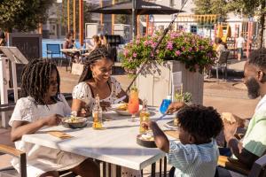 a group of people sitting around a table eating food at Summio Parc Aquadelta in Bruinisse