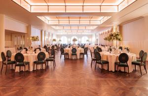 a banquet hall with white tables and chairs at County Arms Birr in Birr
