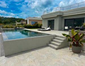 a house with a swimming pool in front of it at Luxury Villa in Calabria in Gasponi