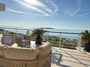 a balcony with chairs and a view of the ocean at Villa Tempera in Vis