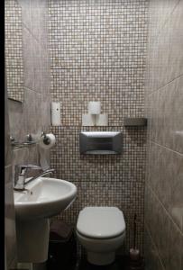 a bathroom with a toilet and a sink at Good driams Xoctel in Kyiv
