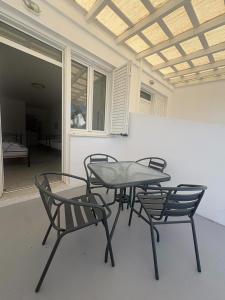 a table and chairs in a room with a window at Summer Time in Ios Chora