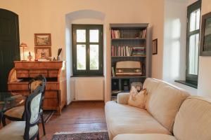 a living room with a couch and a piano at Villa Rustica Vendégház Sümeg in Sümeg