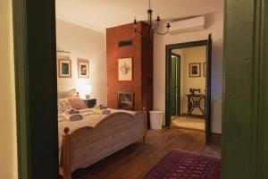 a bedroom with a bed and a hallway with a mirror at Villa Rustica Vendégház Sümeg in Sümeg
