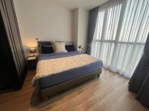 a bedroom with a bed and a large window at Breath Taking View, Amazing Sea View Room in Pattaya South