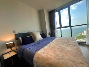 a bedroom with a large bed with a large window at Breath Taking View, Amazing Sea View Room in Pattaya South +83 photos