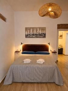 a bedroom with a bed with two towels on it at Dimora Febo in Centro Storico in Piombino