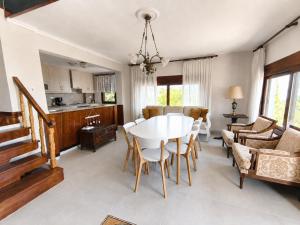 a kitchen and living room with a table and chairs at Villa LaThea in Akti Salonikiou