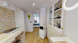 a kitchen with white walls and a brick wall at Dante 25 in Triggiano