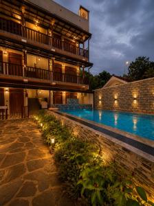 a hotel with a swimming pool at night at AZORA Boutique Studios in Ahangama