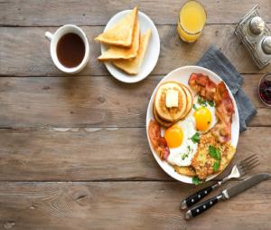 a plate of breakfast food with eggs and toast at Hotel GRAN-SOL Near DELHI Airport in New Delhi
