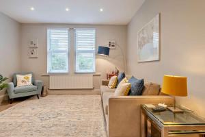 a living room with a couch and a chair at Beach Walk Southbourne SOBO Beach Sleeps 4 in Southbourne
