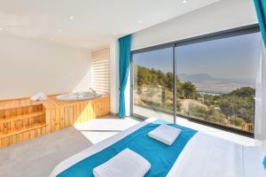 a bedroom with a tub and a bed and a large window at SHB Villas Kalkan in Kaş +196 photos