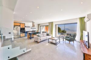 a living room with a couch and a table at SHB Villas Kalkan in Kaş