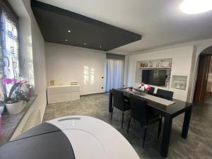 a living room with a dining room table with chairs at Casa Sole in Fenis