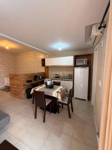 a kitchen and dining room with a table and chairs at Loft 102 Farol de Santa Marta in Laguna