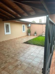 a patio with a fence in front of a house at Marisol in Apóstoles +7 photos