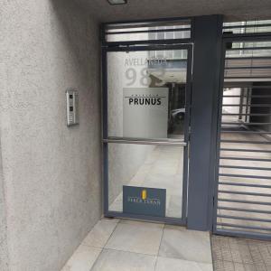 a front door of a store with a sign in the window at monoambiente castelar in Castelar +1 photo