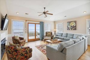 a living room with a couch and chairs at Dream Catcher - Nags Head MP 12, Oceanfront, Elevator, Pool, Hot Tub, Pets OK, YR Flex in Nags Head +56 photos